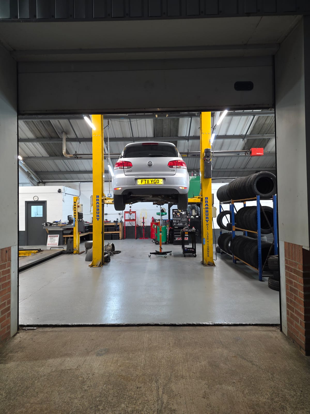 Car lifted in garage for MOT test inspection at Apex MOT & Autocare York