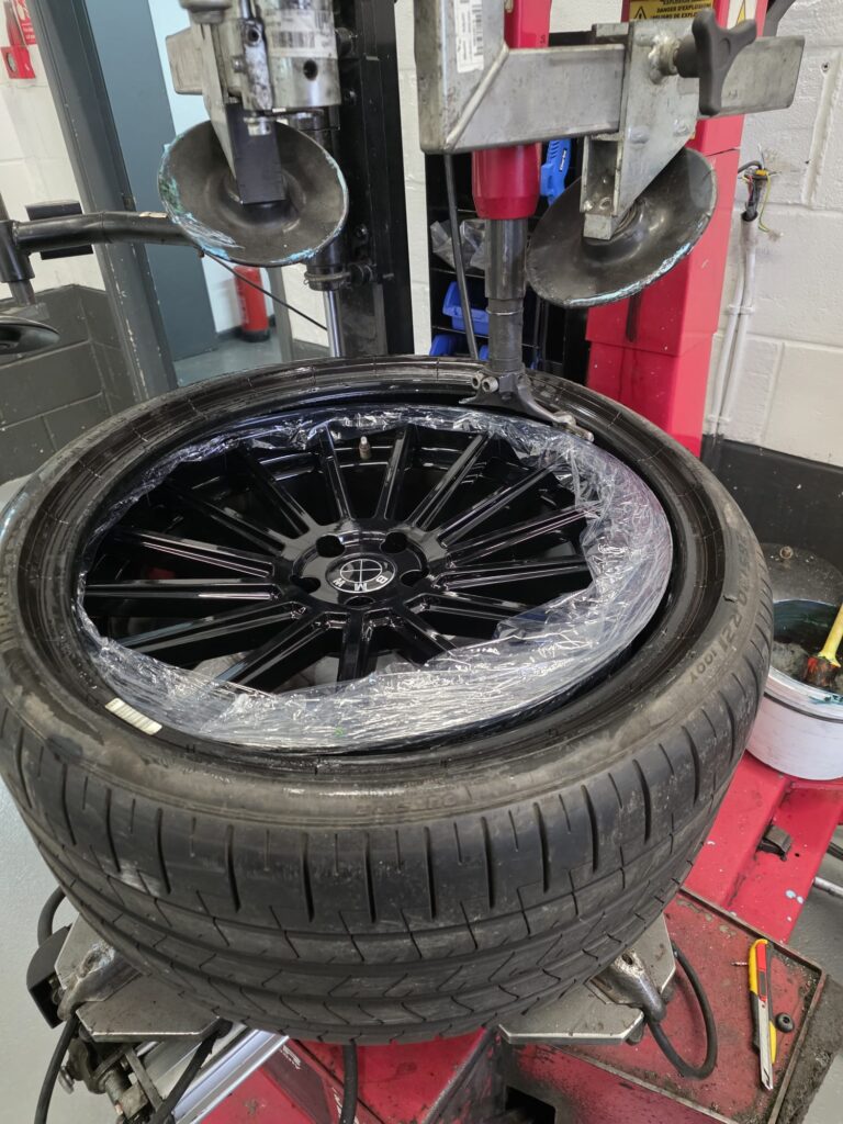 Tyre being fitted onto alloy wheel using machine at Apex MOT & Autocare York
