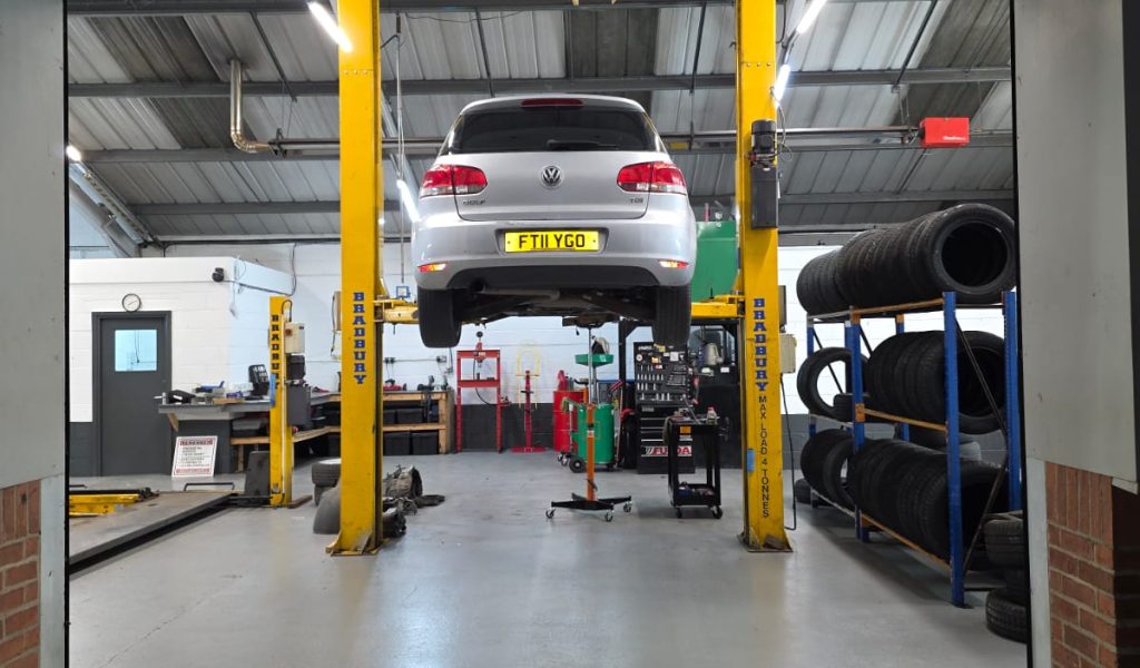 Car lifted in garage for MOT test inspection at Apex MOT & Autocare York